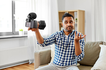 Image showing male video blogger with camera blogging at home