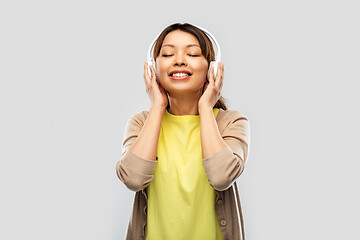 Image showing asian woman in headphones listening to music