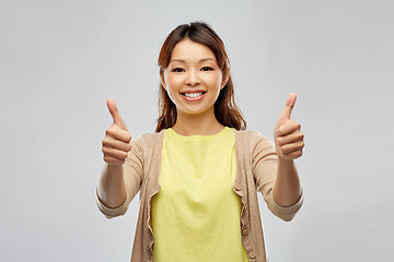 Image showing happy asian woman showing thumbs up