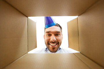 Image showing happy man opening parcel box or birthday gift