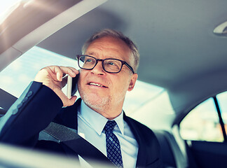 Image showing senior businessman calling on smartphone in car