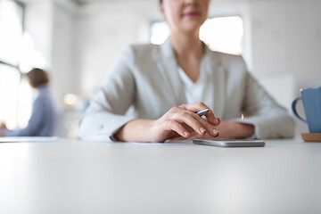 Image showing businesswoman using smartphone at office