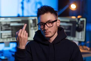 Image showing hacker with computers showing middle finger