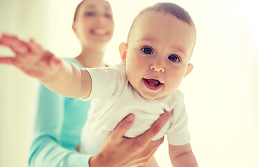 Image showing happy young mother with little baby at home