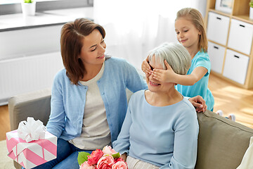 Image showing mother and daughter greeting grandmother at home