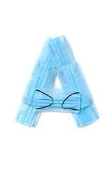 Image showing Letter A made from protective medical masks on a white background.