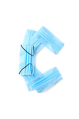 Image showing Letter C made from protective medical masks on a white background.