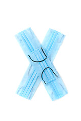 Image showing Letter X made from protective medical masks on a white background.