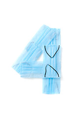 Image showing Number four made from protective medical masks on a white background.