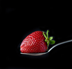 Image showing fresh ripe strawberry on black background