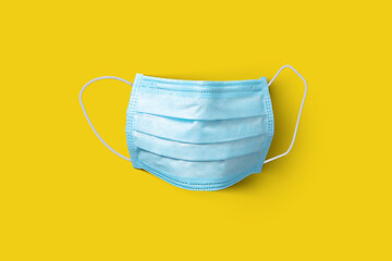 Image showing Medical protective mask on a yellow background. Top view.