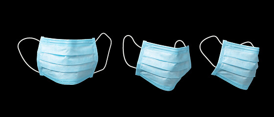 Image showing Three medical masks for protection on a black background.