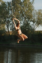 Image showing Rope swing river jump