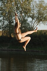 Image showing Rope swing river jump