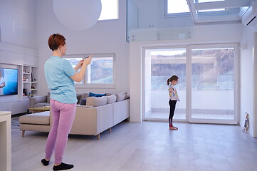 Image showing family at home little girl have online ballet training