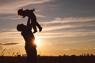 Image showing Father and son playing in the park at the sunset time.