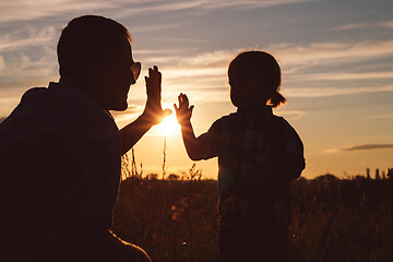 Image showing Father and son playing in the park at the sunset time.