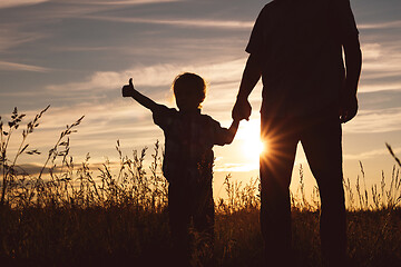 Image showing Father and son playing in the park at the sunset time.