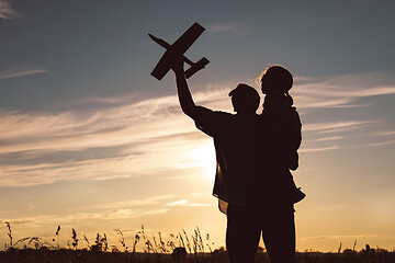 Image showing Father and son playing in the park at the sunset time.