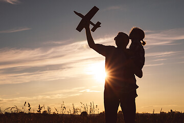 Image showing Father and son playing in the park at the sunset time.