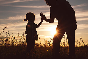 Image showing Father and son playing in the park at the sunset time.