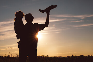 Image showing Father and son playing in the park at the sunset time.