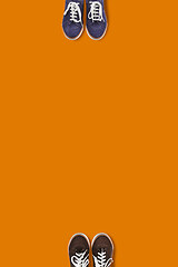 Image showing Top view of people feet on the orange background as a social distancing.