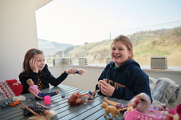 Image showing little girls playing with dolls