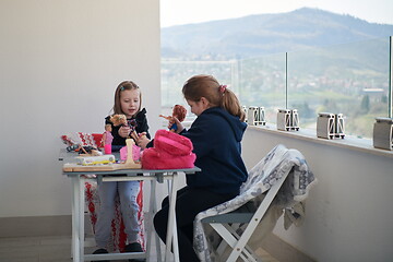 Image showing little girls playing with dolls