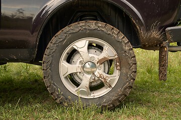 Image showing Rear wheel of a 4x4 vehicle dirty with mud