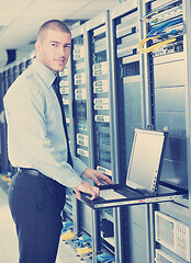 Image showing young it engeneer in datacenter server room