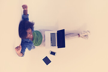 Image showing african american woman sitting on floor with laptop top view