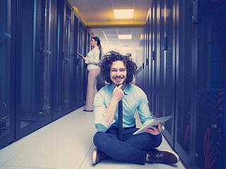 Image showing young technicians working together on servers