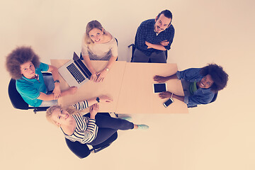 Image showing Multiethnic startup business team on meeting  top view