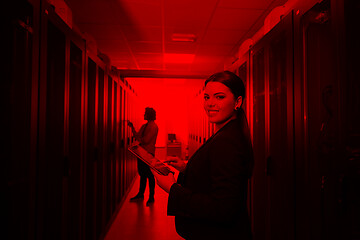 Image showing Female engineer working on a tablet computer in server room