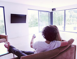 Image showing Rear view of couple watching television