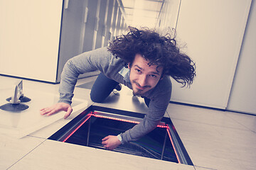 Image showing engineer connecting cables in server room