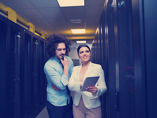 Image showing engineer showing working data center server room to female chief