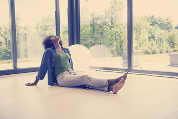 Image showing african american  woman  sitting near window