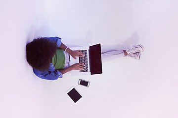 Image showing african american woman sitting on floor with laptop top view