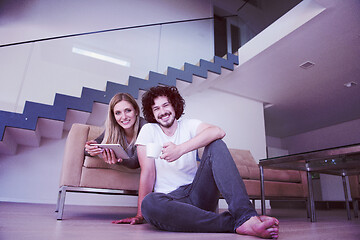 Image showing couple relaxing at  home with tablet computers