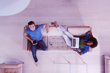 Image showing young multiethnic couple relaxes in the living room top view