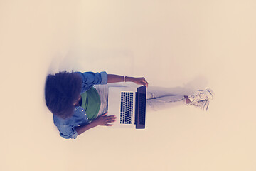 Image showing african american woman sitting on floor with laptop top view