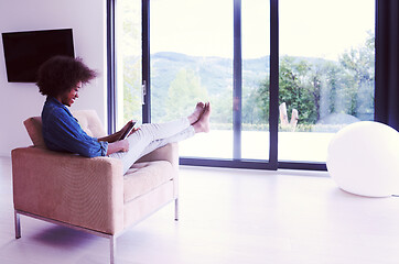 Image showing african american woman at home with digital tablet