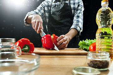 Image showing Preparing salad. Female chef cutting fresh vegetables. Cooking process. Selective focus