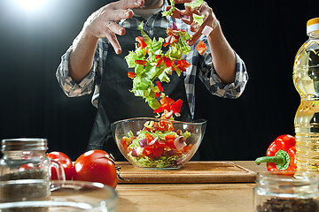 Image showing Preparing salad. Female chef cutting fresh vegetables. Cooking process. Selective focus