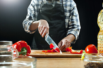 Image showing Preparing salad. Female chef cutting fresh vegetables. Cooking process. Selective focus