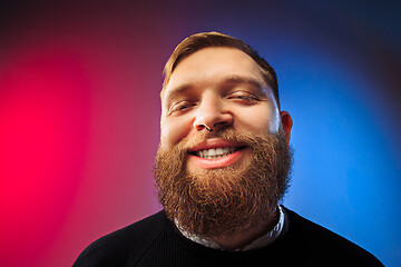 Image showing The happy man standing and smiling against pink background.