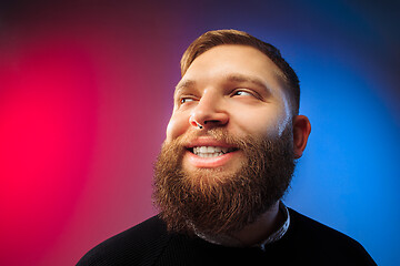 Image showing The happy man standing and smiling against pink background.