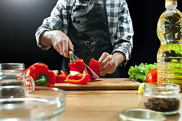 Image showing Preparing salad. Female chef cutting fresh vegetables. Cooking process. Selective focus